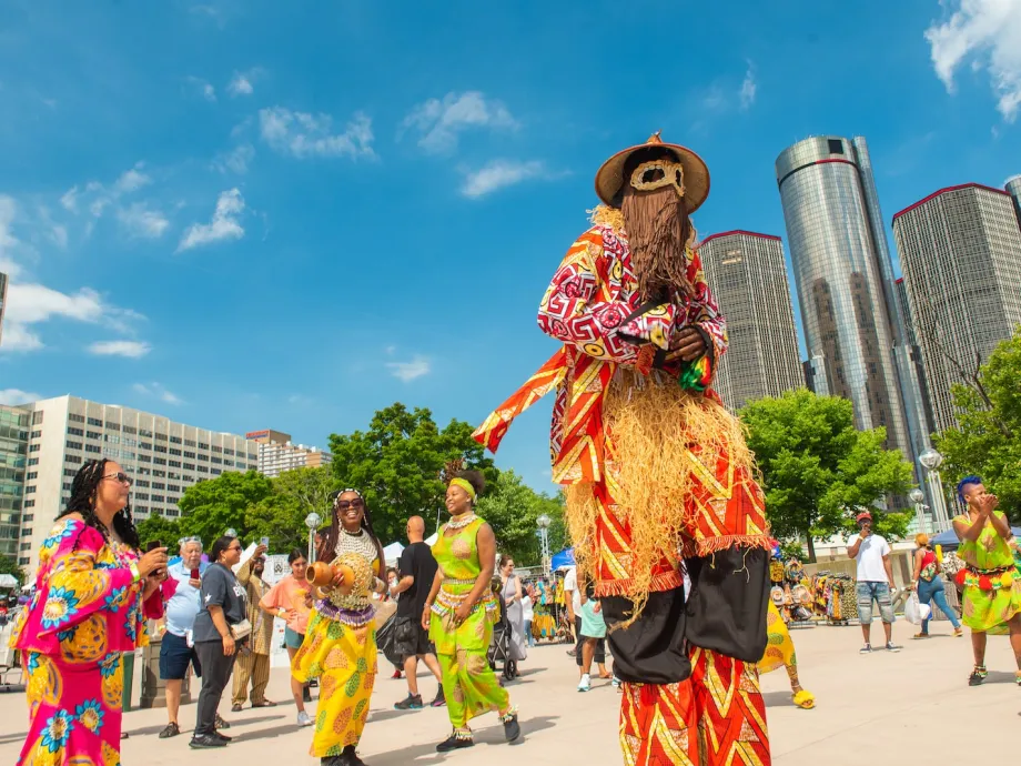 Masked performer on stilts at African World Festival