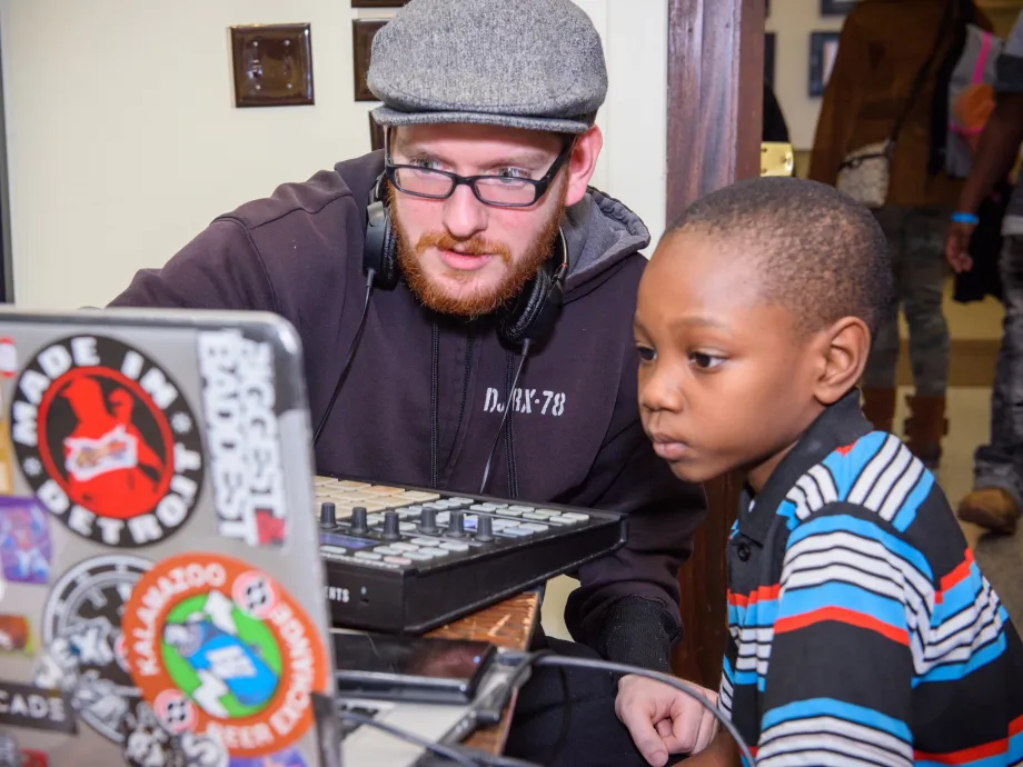 Man teaching kid on computer