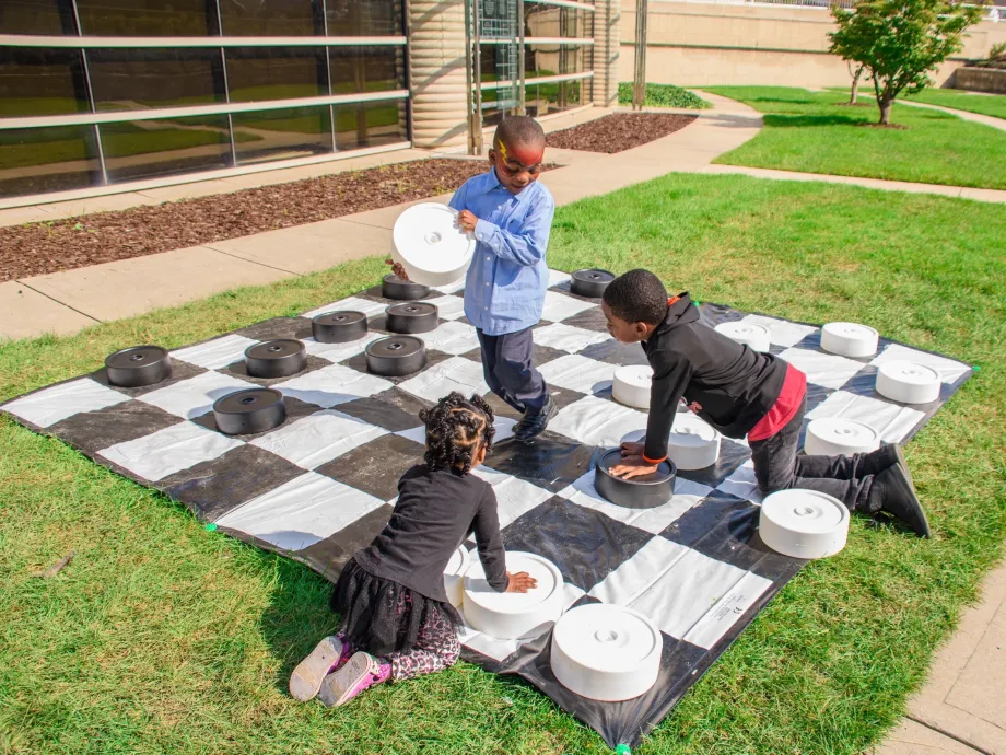 Kids playing giant game of checkers