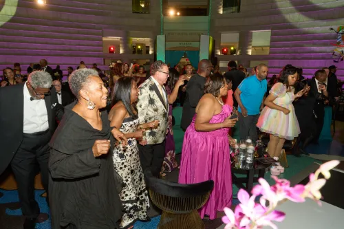 Room full of people dressed up and dancing.